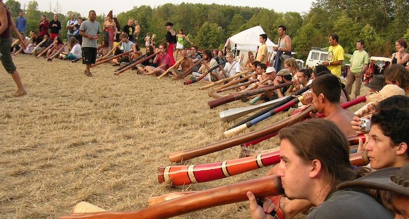 Dozens of didgeridoo players playing together