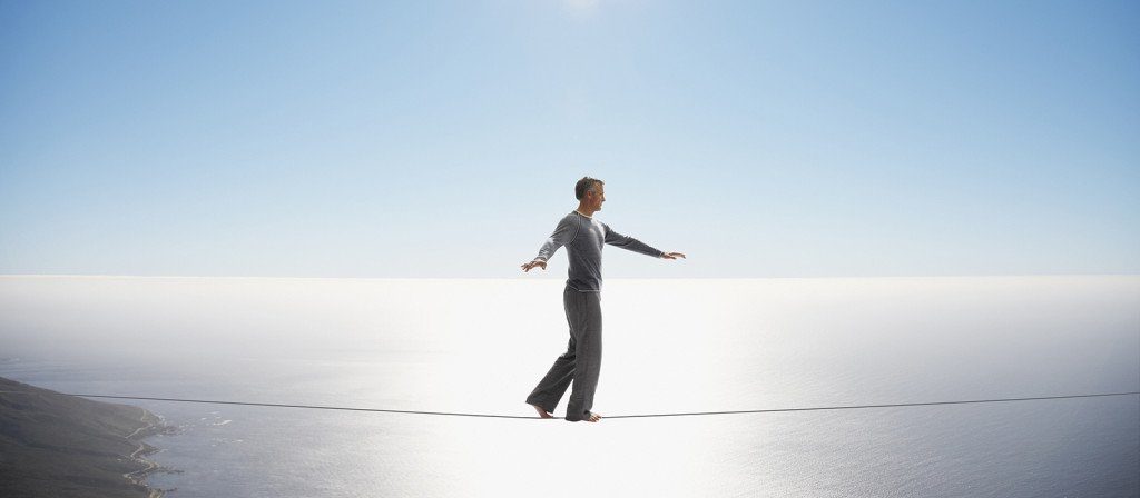 Male merchant balancing on a rope